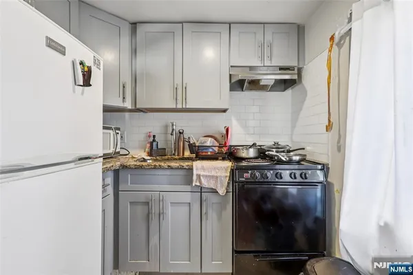 a kitchen with a stove and a refrigerator