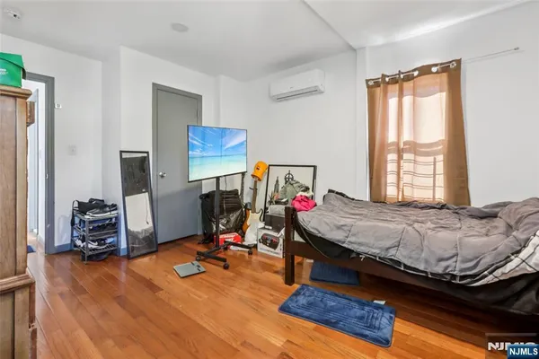a bedroom with bed and a window