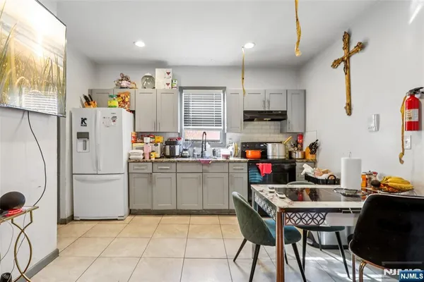 a kitchen with refrigerator and cabinets