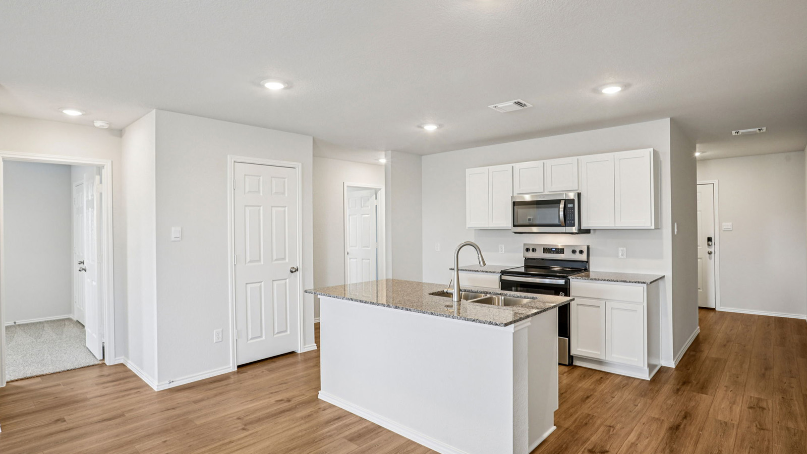 148 Wyatt Way Jarrell, TX 76537 - Photo 2 of 33 Kitchen island with granite countertop and double stainless steel sink