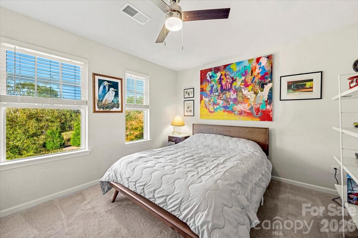 134 Dry Rivers Lane Mooresville, NC 28117 - Photo 18 of 29 a bedroom with a bed painting on wall and a large window
