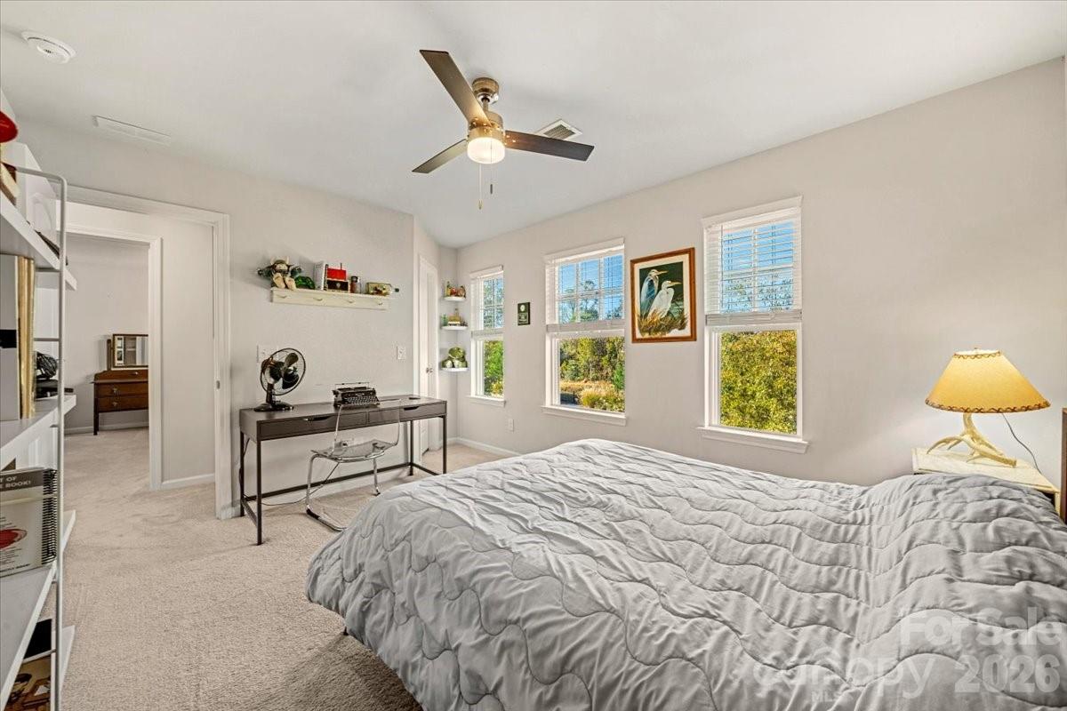 134 Dry Rivers Lane Mooresville, NC 28117 - Photo 19 of 29 a bedroom with a bed and a chandelier