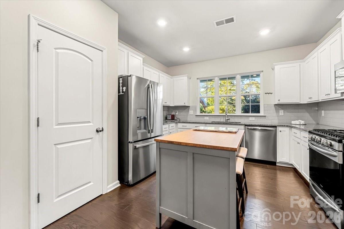 134 Dry Rivers Lane Mooresville, NC 28117 - Photo 8 of 29 a kitchen with stainless steel appliances granite countertop a refrigerator sink and stove