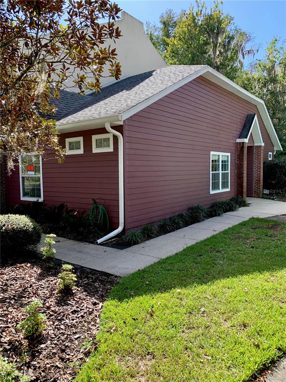 350 Northwest 50th Boulevard, Unit 350 Gainesville, FL 32607 - Photo 1 of 16 a front view of a house with a garden