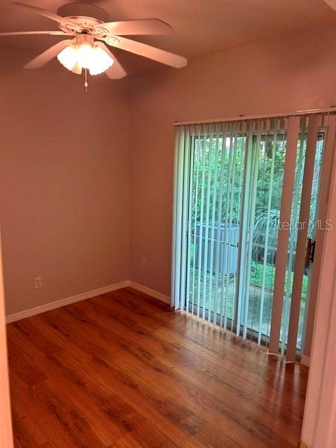 350 Northwest 50th Boulevard, Unit 350 Gainesville, FL 32607 - Photo 11 of 16 wooden floor in an empty room with a window