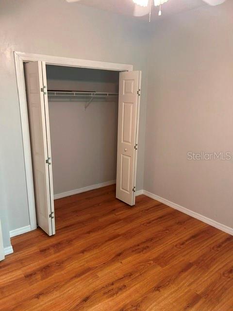 350 Northwest 50th Boulevard, Unit 350 Gainesville, FL 32607 - Photo 12 of 16 an empty room with wooden floor and closet
