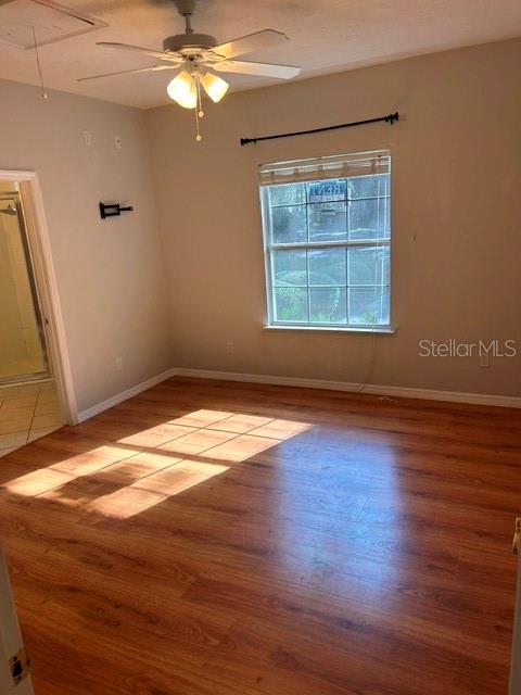 350 Northwest 50th Boulevard, Unit 350 Gainesville, FL 32607 - Photo 7 of 16 an empty room with wooden floor fan and windows