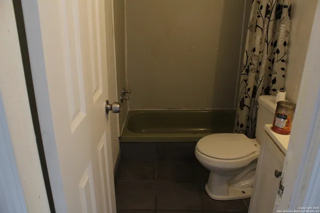 a bathroom with a toilet and a shower