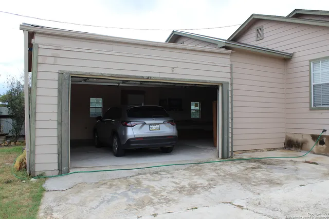 a view of a car in front of garage