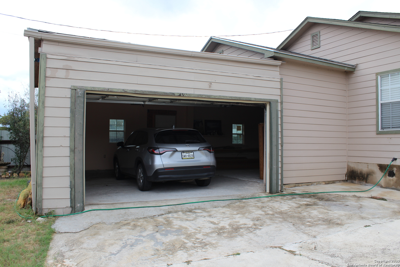 406 County Road 6850, Unit 2 Lytle, TX 78052 - Photo 2 of 15 a view of a car in front of garage