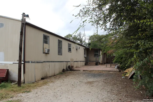 a backyard of a house with shaded area