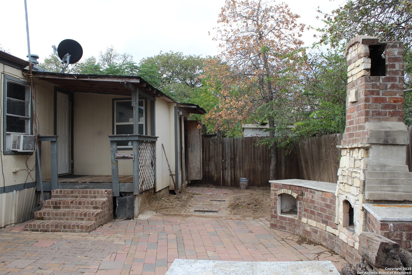 406 County Road 6850, Unit 2 Lytle, TX 78052 - Photo 5 of 15 a backyard of a house with barbeque oven and outdoor seating