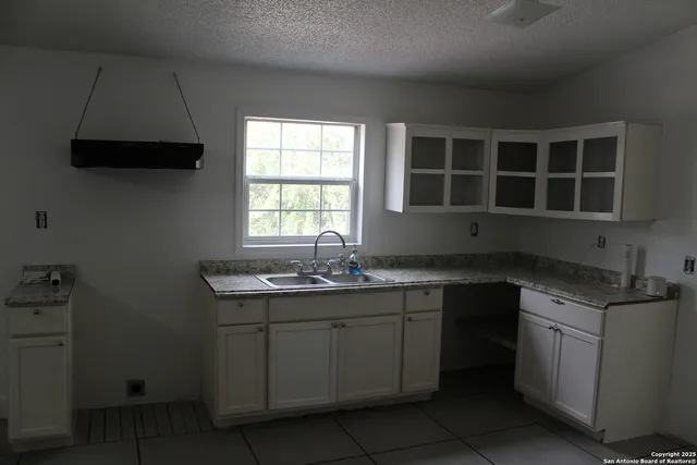 a kitchen with a sink and cabinets