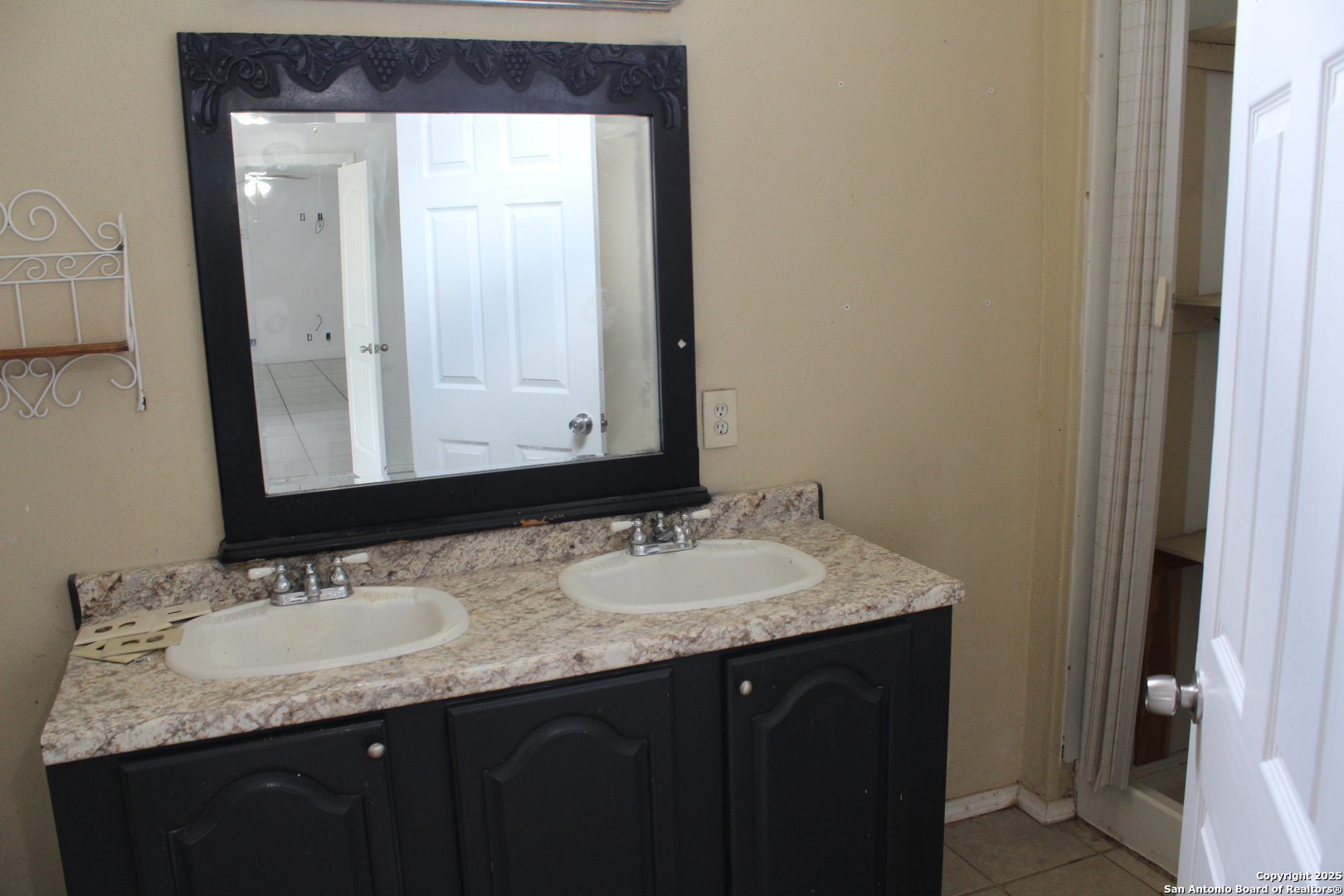 406 County Road 6850, Unit 2 Lytle, TX 78052 - Photo 9 of 15 a bathroom with a granite countertop sink and a mirror