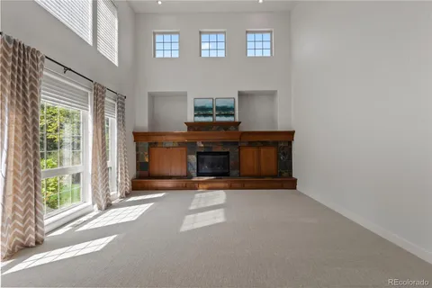 a view of a livingroom with a fireplace and window