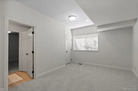 a view of a kitchen with white cabinets