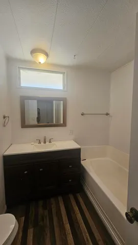 a bathroom with a bathtub and a sink