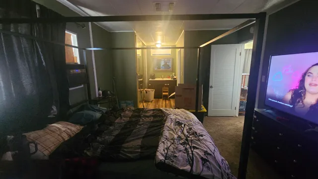 a bedroom with bed and window