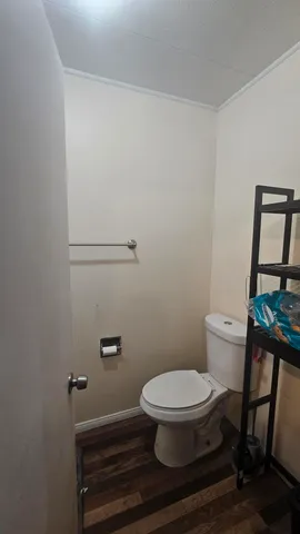 a white toilet sitting next to a small bathroom