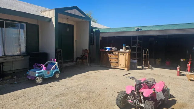 a living room with furniture a flat screen tv and a couch