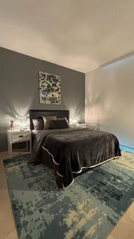 a bedroom with a bed and a view of bathroom