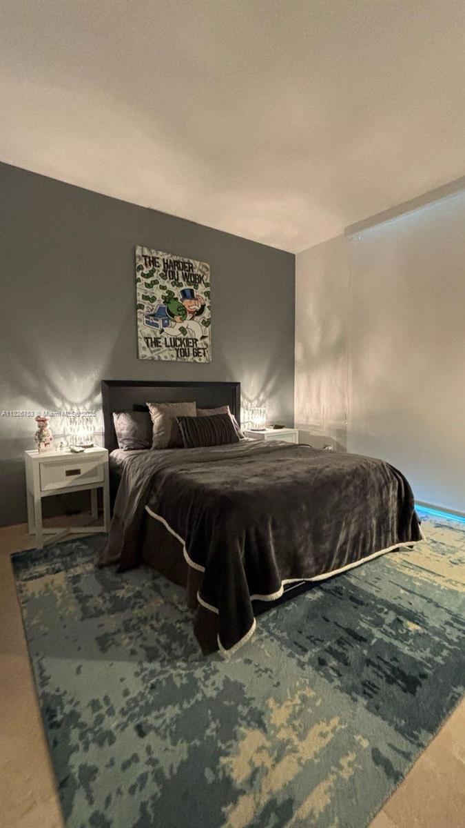68 Southeast 6th Street, Unit 2804 Miami, FL 33131 - Photo 11 of 41 a bedroom with a bed and a view of bathroom