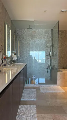 a bathroom with a sink a mirror and a shower