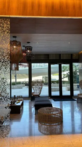 a living room with furniture and a floor to ceiling window