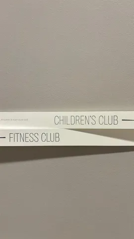 a living room with large windows and a chandelier