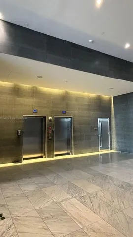 a living room with stainless steel appliances