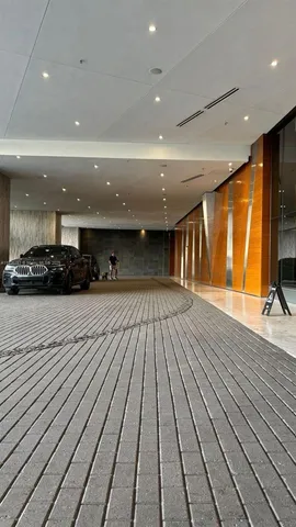 a view of a hall with the bricks wall and laminate floor