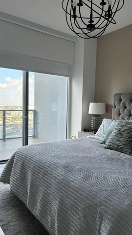 a bedroom with a large bed and a window