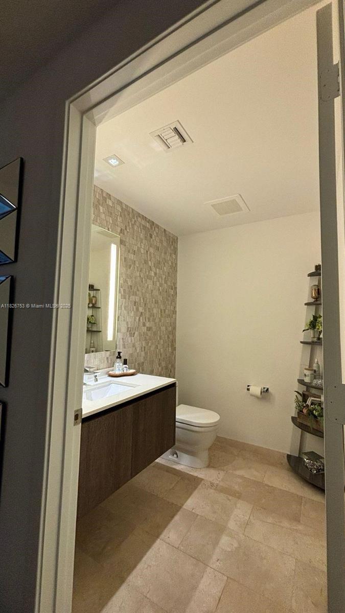 68 Southeast 6th Street, Unit 2804 Miami, FL 33131 - Photo 10 of 41 a bathroom with a sink a toilet and shower