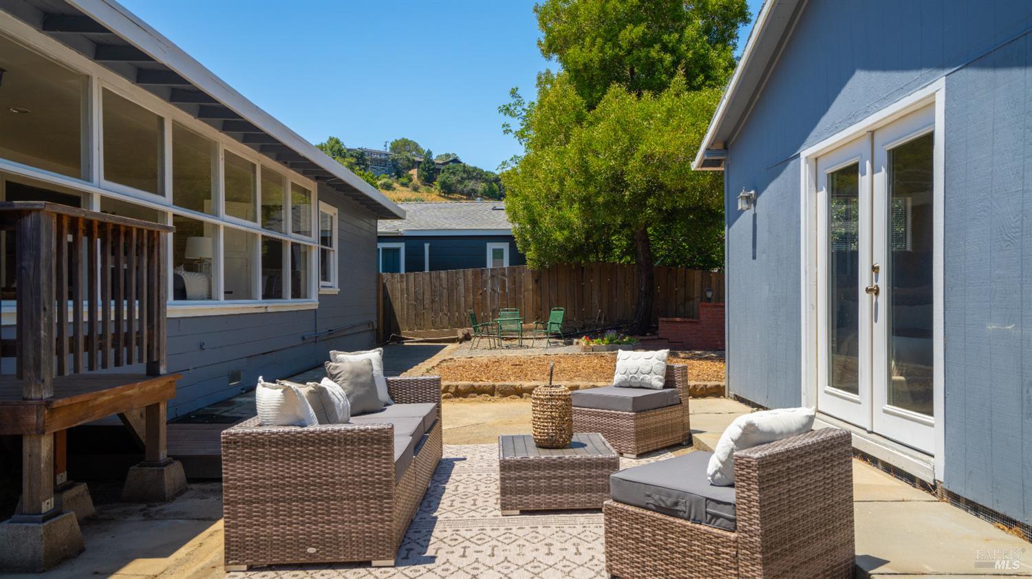 38 Bret Avenue San Rafael, CA 94901 - Photo 37 of 52 a view of a patio with couches and a fire pit and wooden fence