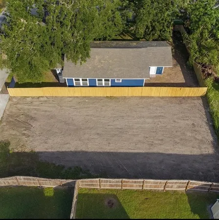 a view of swimming pool with lawn chair and trees