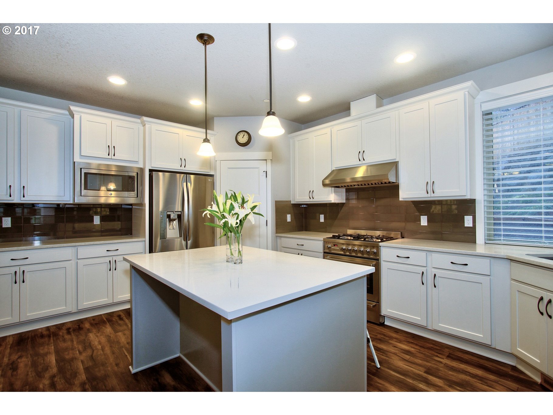 12723 Southwest Willow Point Lane Tigard, OR 97224 - Photo 2 of 27 a kitchen with kitchen island white cabinets and white appliances