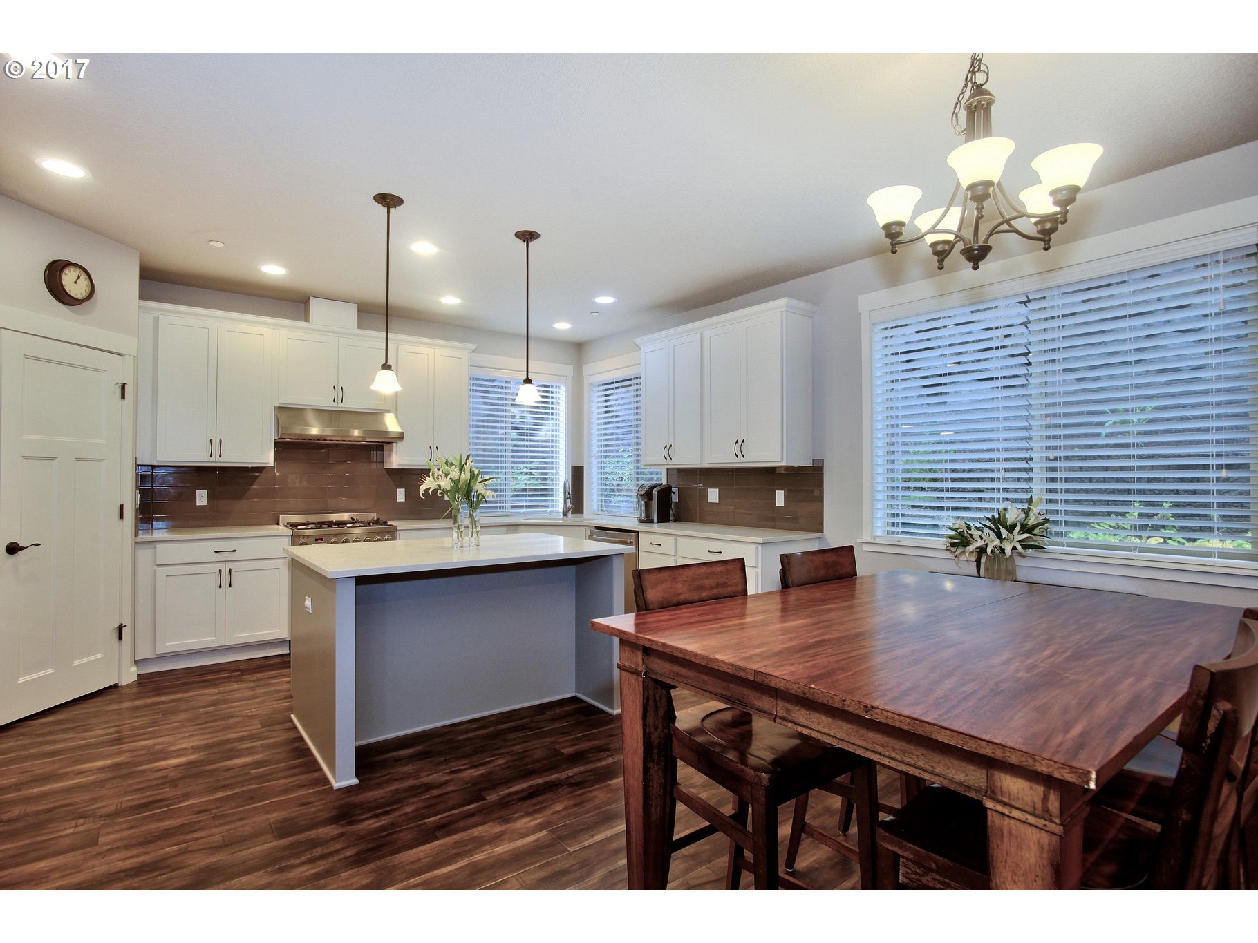 12723 Southwest Willow Point Lane Tigard, OR 97224 - Photo 6 of 27 a kitchen with a table chairs stove and cabinets