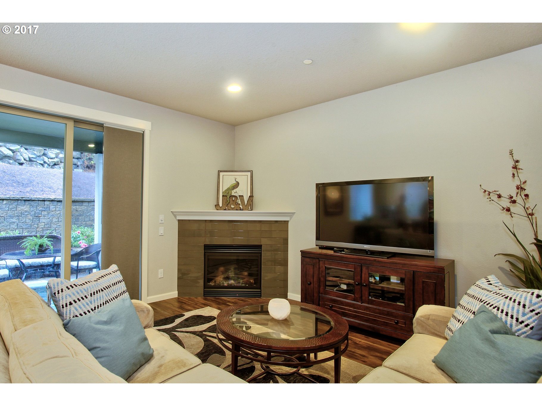 12723 Southwest Willow Point Lane Tigard, OR 97224 - Photo 7 of 27 a living room with furniture a flat screen tv and a fireplace