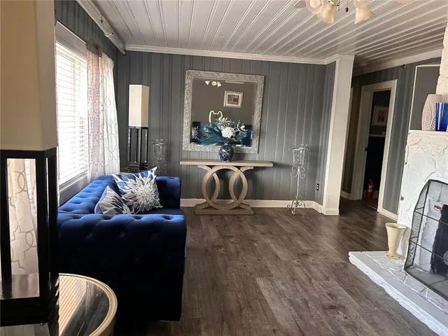 a living room with furniture and a dining table