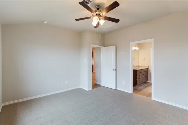 a view of a livingroom with a ceiling fan and window