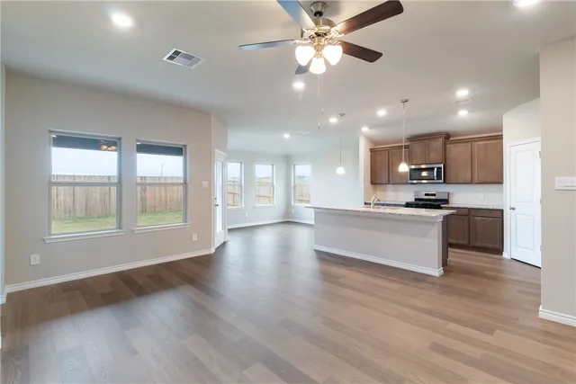 a view of kitchen with sink and wooden floor