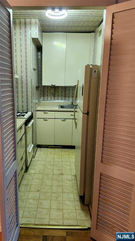 6600 Boulevard East, Unit 8A West New York, NJ 07093 - Photo 15 of 24 a room with water heater and wooden cabinets