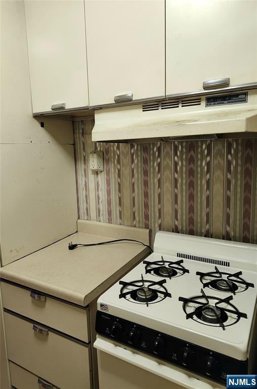 6600 Boulevard East, Unit 8A West New York, NJ 07093 - Photo 16 of 24 a white stove top oven sitting inside of a kitchen