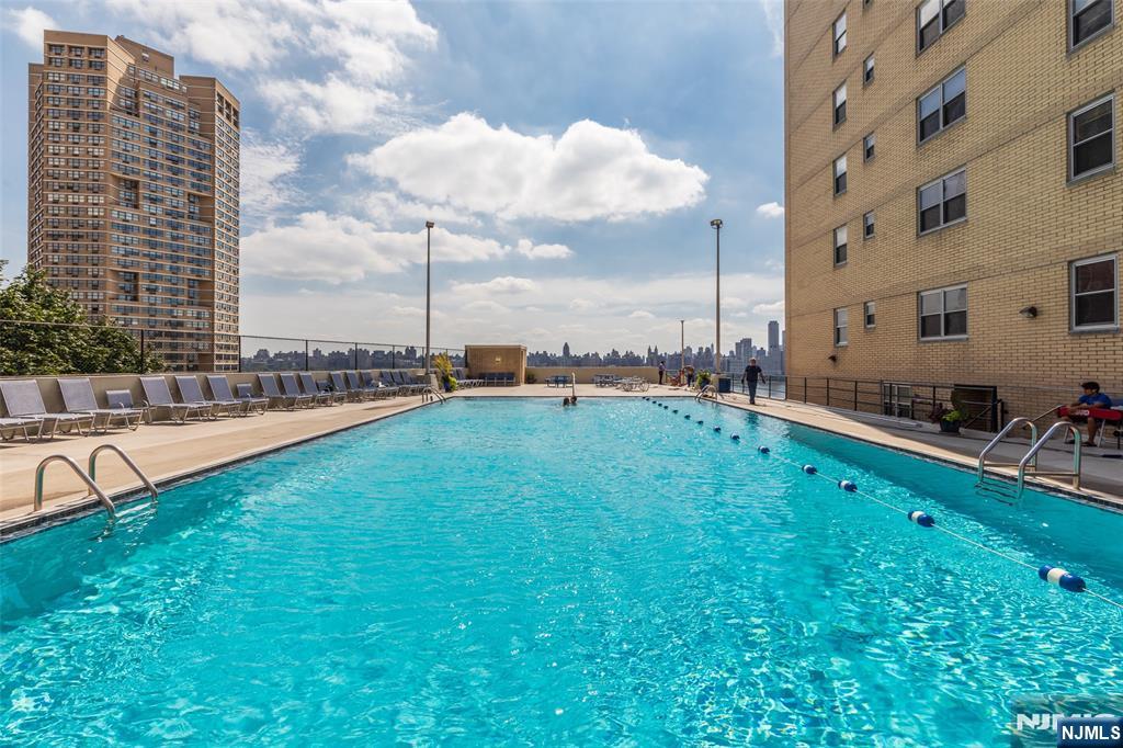 6600 Boulevard East, Unit 8A West New York, NJ 07093 - Photo 9 of 24 a view of a swimming pool with a garden and chairs