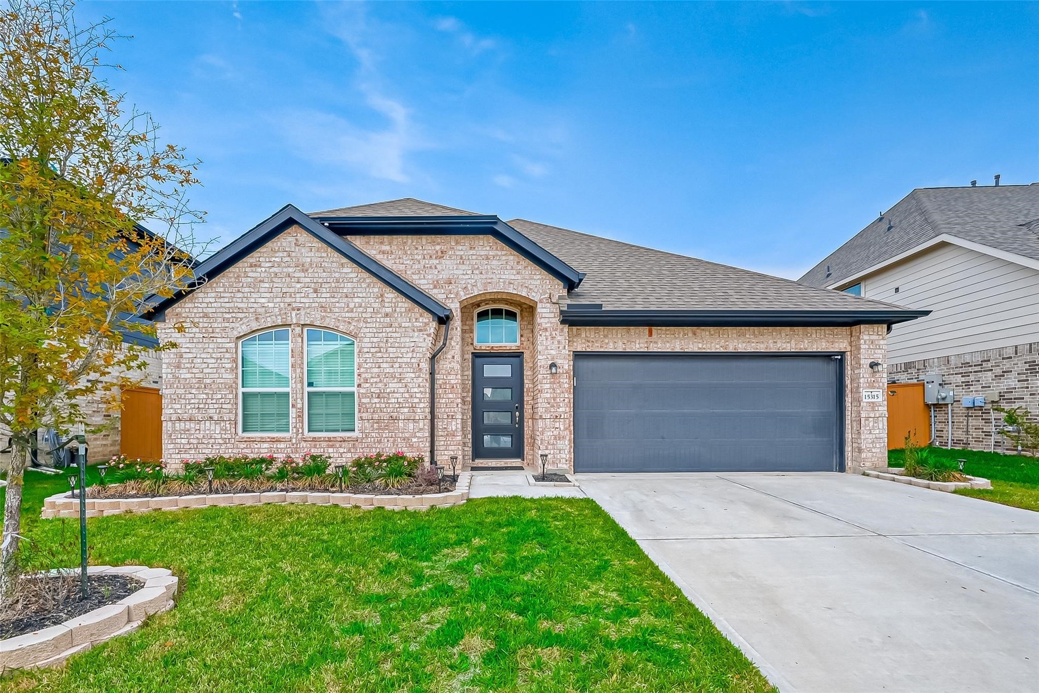 a front view of a house with a yard and garage