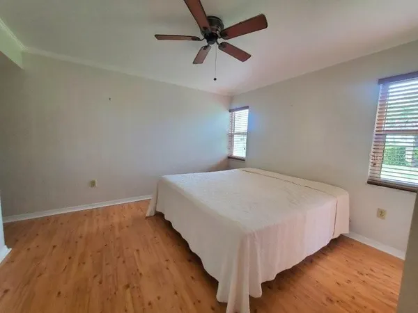 a bed sitting in a spacious bedroom next to a window