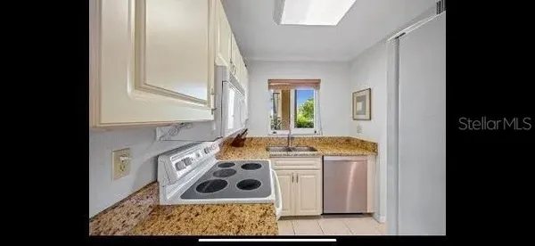 a kitchen with a stove and a refrigerator