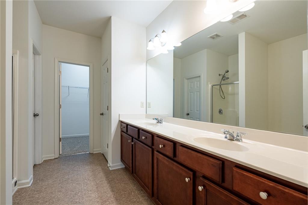 3207 Cyrus Point Lane Kennesaw, GA 30152 - Photo 18 of 24 a bathroom with double vanity sinks and a mirror