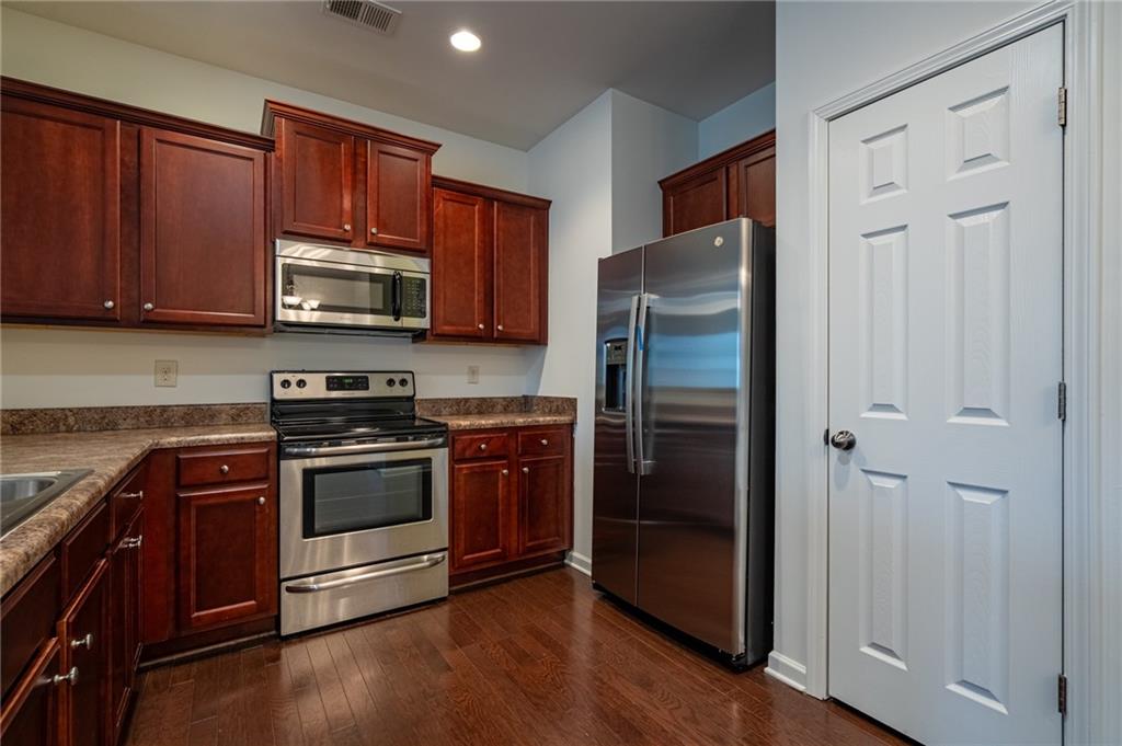 3207 Cyrus Point Lane Kennesaw, GA 30152 - Photo 7 of 24 a kitchen with stainless steel appliances granite countertop a refrigerator stove and sink
