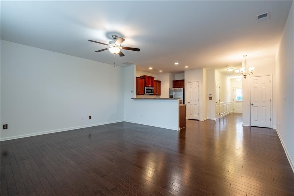 3207 Cyrus Point Lane Kennesaw, GA 30152 - Photo 8 of 24 an empty room with wooden floor and windows